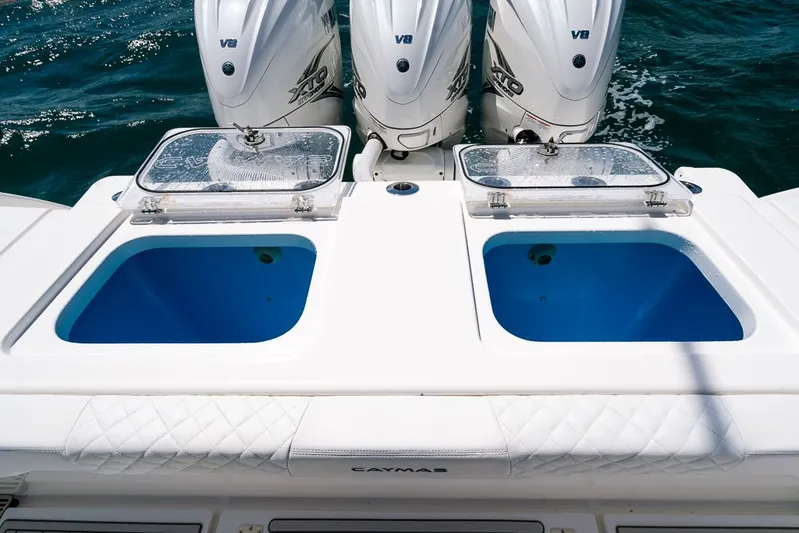 Caymas Yacht Photos Pics 2023 Caymas 401CC boat with dual livewells and triple V8 engines on the ocean.