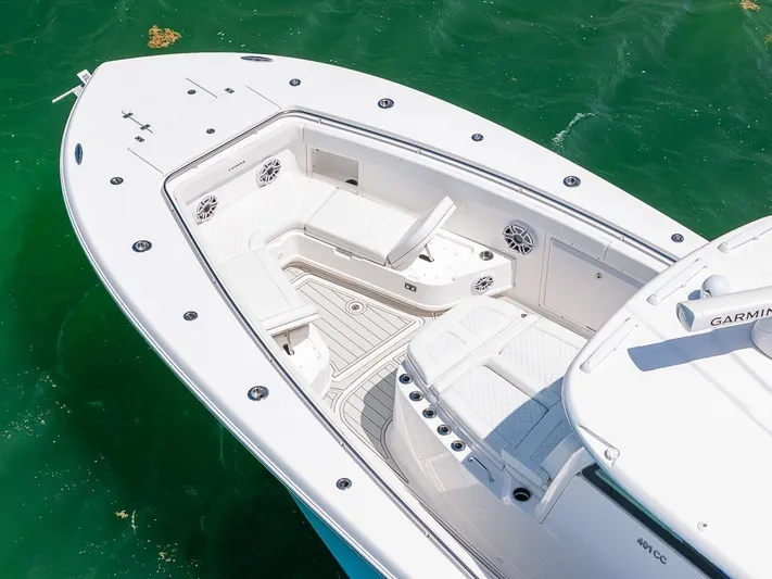 Caymas Yacht Photos Pics 2023 Caymas 401CC boat with spacious deck and seating, floating on clear green water.