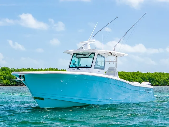 Caymas Yacht Photos Pics 2023 Caymas 401 CC boat on clear blue water under a sunny sky.