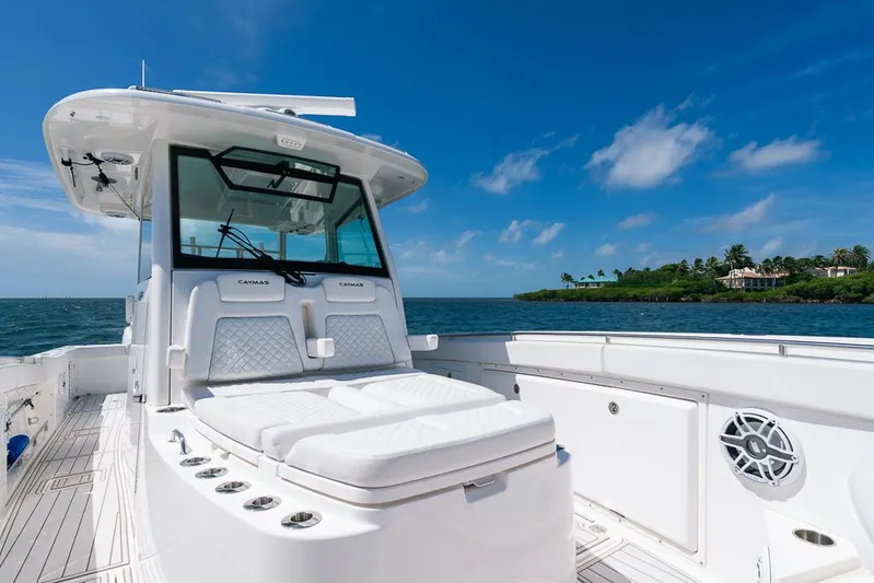 Caymas Yacht Photos Pics 2023 Caymas 401CC boat on open water, featuring sleek design and luxurious seating.