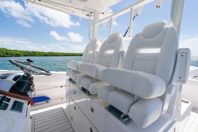 Caymas Yacht Photos Pics 2023 Caymas 401CC boat interior with luxurious white seating and steering wheel.