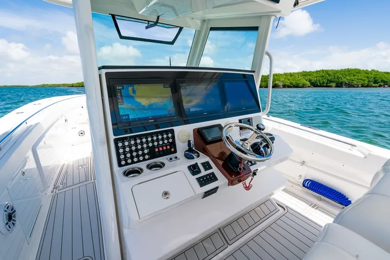 Caymas Yacht Photos Pics 2023 Caymas 401CC boat dashboard with advanced navigation system on open water.