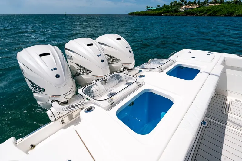 Caymas Yacht Photos Pics 2023 Caymas 401CC boat with triple Yamaha V8 engines on open water.