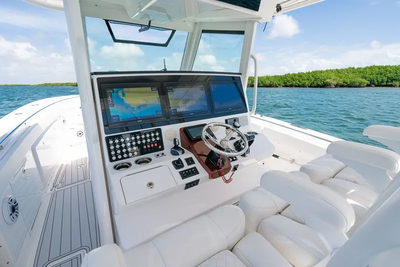 Caymas Yacht Photos Pics 2023 Caymas 401CC boat cockpit with advanced navigation system and luxurious seating on open water.