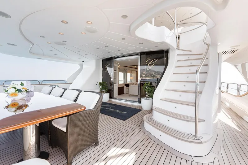 Georgia I Yacht Photos Pics Luxurious 2009 Benetti Classic 120 yacht deck with elegant dining area and spiral staircase.