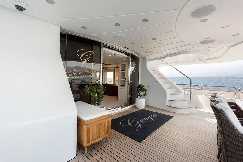Georgia I Yacht Photos Pics Luxurious Benetti Classic 120 yacht deck, 2009 model, featuring elegant seating and ocean view.