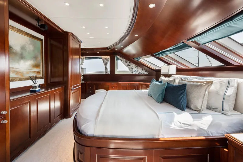 Georgia I Yacht Photos Pics Luxurious bedroom interior on 2009 Benetti Classic 120 yacht, featuring elegant wood paneling and plush bedding.