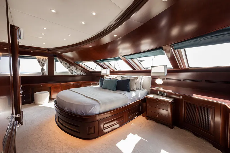 Georgia I Yacht Photos Pics Luxurious bedroom interior of 2009 Benetti Classic 120 yacht with elegant wood finishes and large windows.