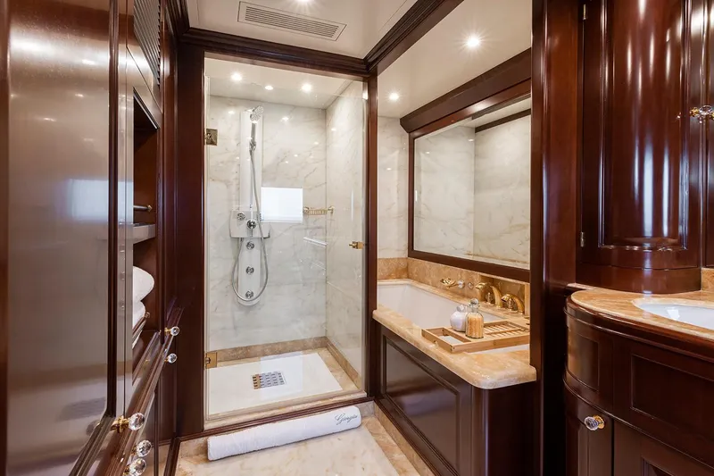 Georgia I Yacht Photos Pics Luxurious bathroom on 2009 Benetti Classic 120 yacht, featuring marble and rich wood finishes.