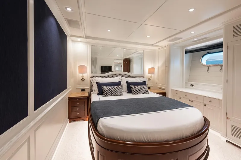 Georgia I Yacht Photos Pics Luxurious bedroom interior on 2009 Benetti Classic 120 yacht, featuring elegant design and cozy ambiance.
