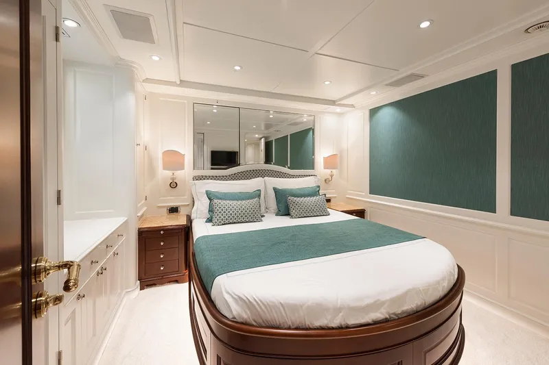 Georgia I Yacht Photos Pics Luxurious bedroom interior on 2009 Benetti Classic 120 yacht, featuring elegant decor and plush bedding.