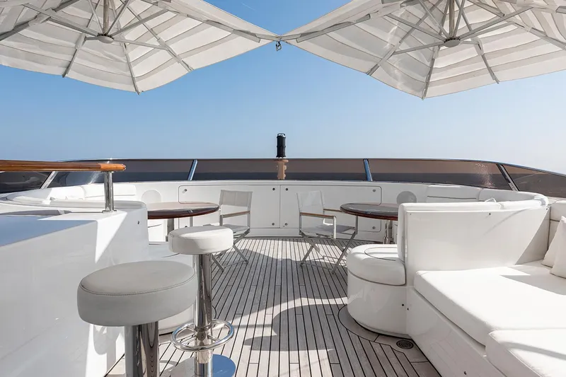 Georgia I Yacht Photos Pics Luxurious deck of 2009 Benetti Classic 120 yacht with seating and umbrellas.