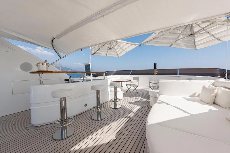 Georgia I Yacht Photos Pics Luxurious deck of 2009 Benetti Classic 120 yacht with bar and seating area.