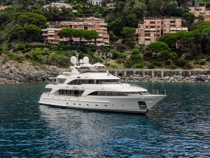 Georgia I Yacht Photos Pics Luxury yacht Benetti Classic 120, 2009, cruising near a scenic coastal landscape.