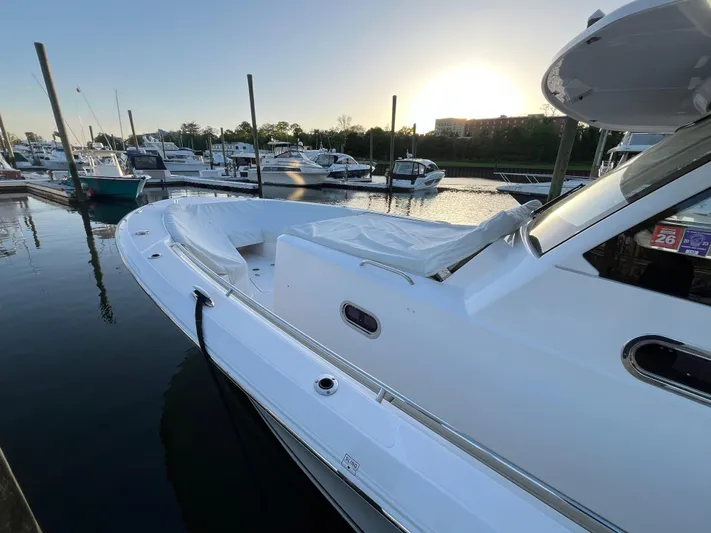 Yacht Photos Pics 2019 Pursuit S 408 Sport boat docked at marina during sunset.