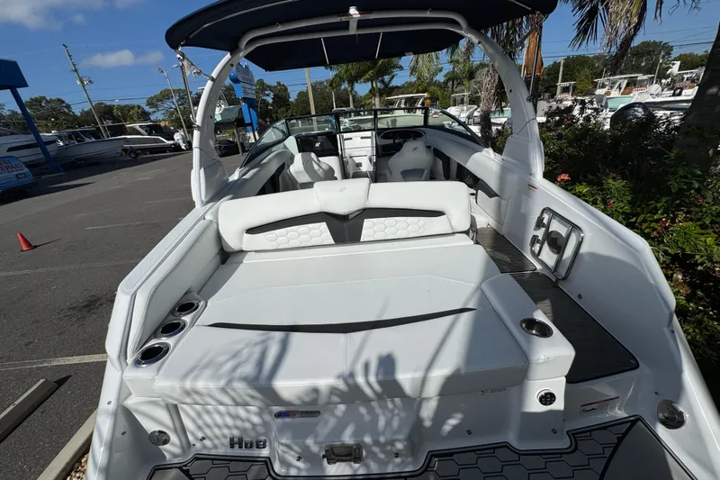  Yacht Photos Pics 2026 Four Winns HD8 OB boat with spacious seating and sleek design in a sunny marina.