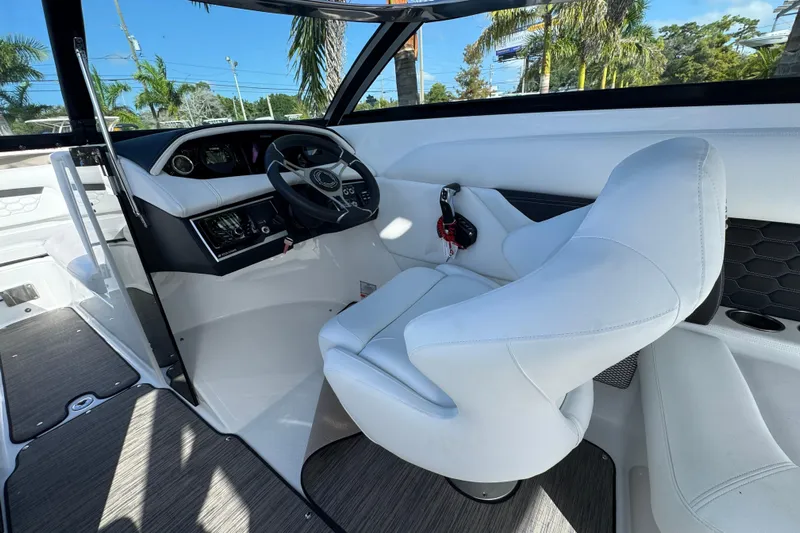  Yacht Photos Pics 2026 Four Winns HD8 OB boat interior with white captain's chair and modern dashboard.
