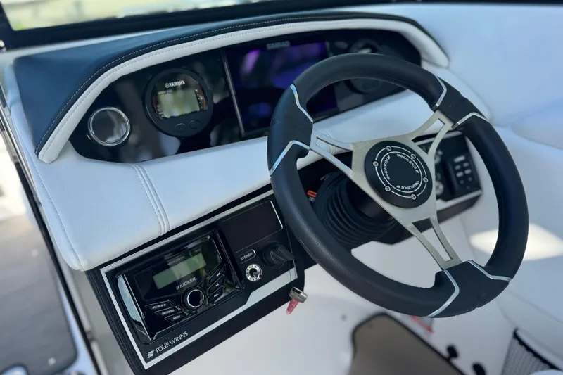  Yacht Photos Pics 2026 Four Winns HD8 OB boat dashboard with steering wheel and control panel.