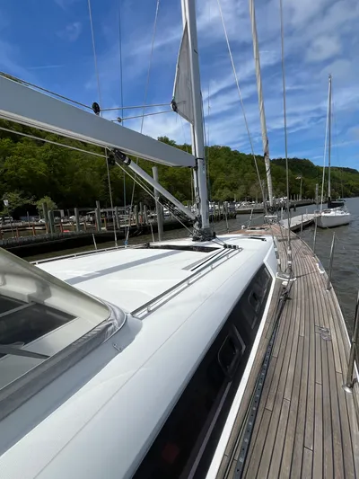 Kilimanjaro Yacht Photos Pics 2012 Beneteau Oceanis 58 sailboat docked, showcasing sleek deck and mast under blue sky.