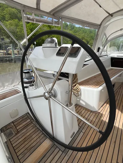 Kilimanjaro Yacht Photos Pics Steering wheel of 2012 Beneteau Oceanis 58 yacht with teak deck and navigation instruments.