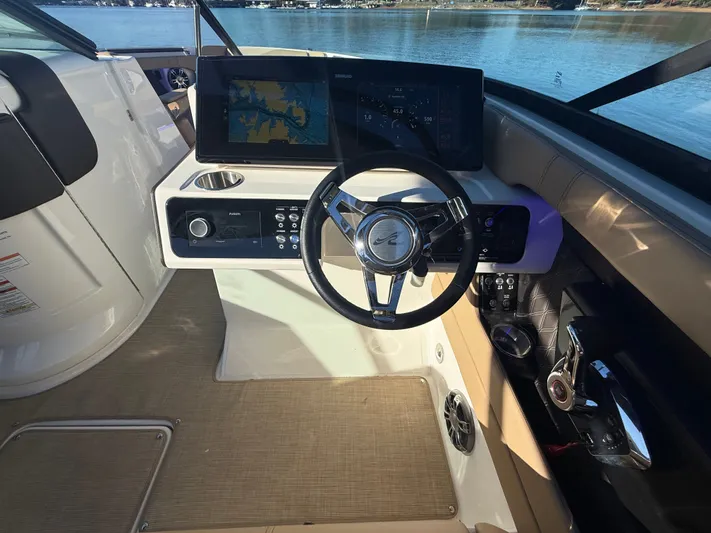  Yacht Photos Pics 2023 Sea Ray 280 SLX boat dashboard with steering wheel and navigation display.