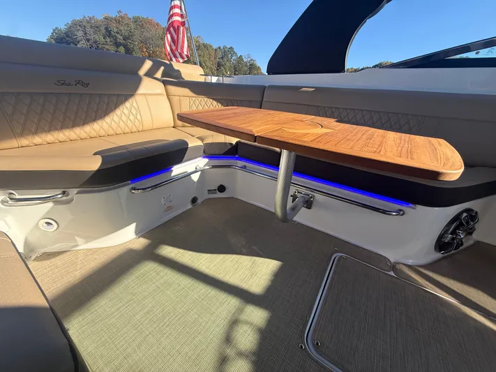  Yacht Photos Pics Luxurious interior of 2023 Sea Ray 280 SLX boat with elegant seating and wooden table.
