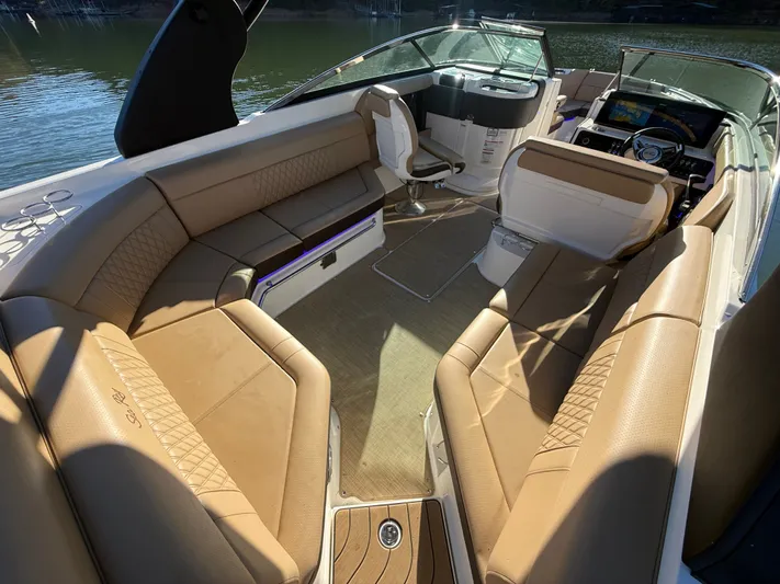  Yacht Photos Pics 2023 Sea Ray 280 SLX boat interior with luxurious tan seating and modern dashboard.
