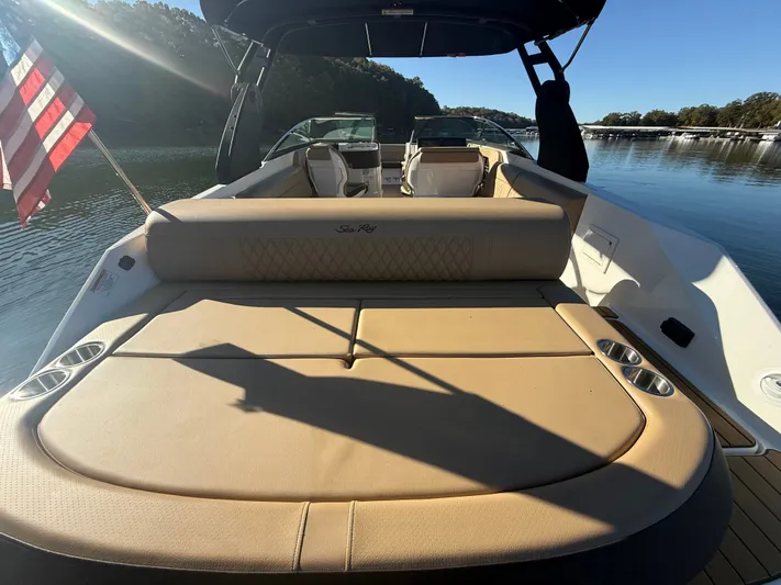  Yacht Photos Pics 2023 Sea Ray 280 SLX boat with spacious seating and American flag on calm water.