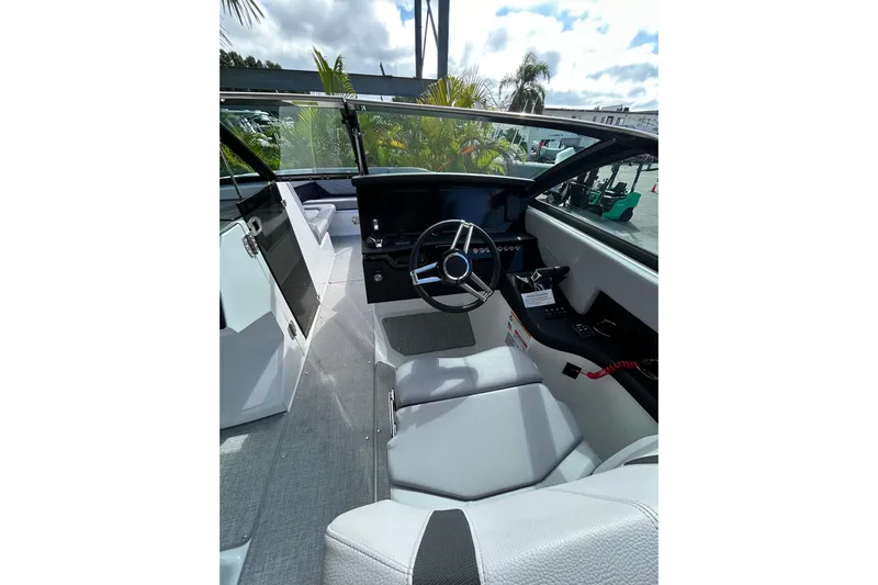  Yacht Photos Pics Interior of 2026 Four Winns H9 OB boat, featuring sleek steering and modern dashboard.