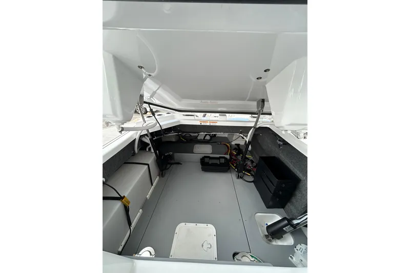  Yacht Photos Pics 2026 Four Winns H9 OB boat interior storage compartment with open hatch and visible wiring.