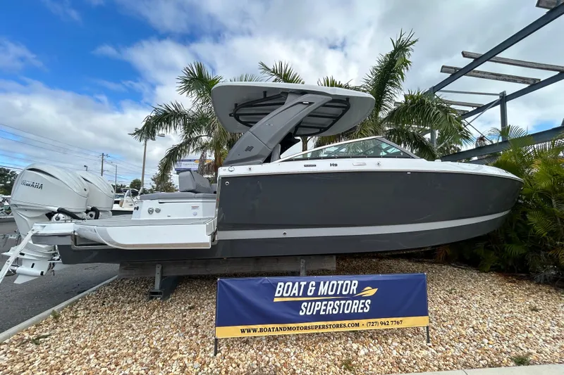  Yacht Photos Pics 2026 Four Winns H9 OB boat displayed at dealership with Yamaha outboard motor.