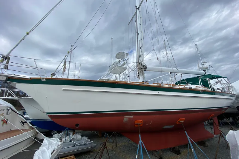 Elation Yacht Photos Pics 2005 Cabo Rico 42 Cutter sailboat on land, under cloudy skies.