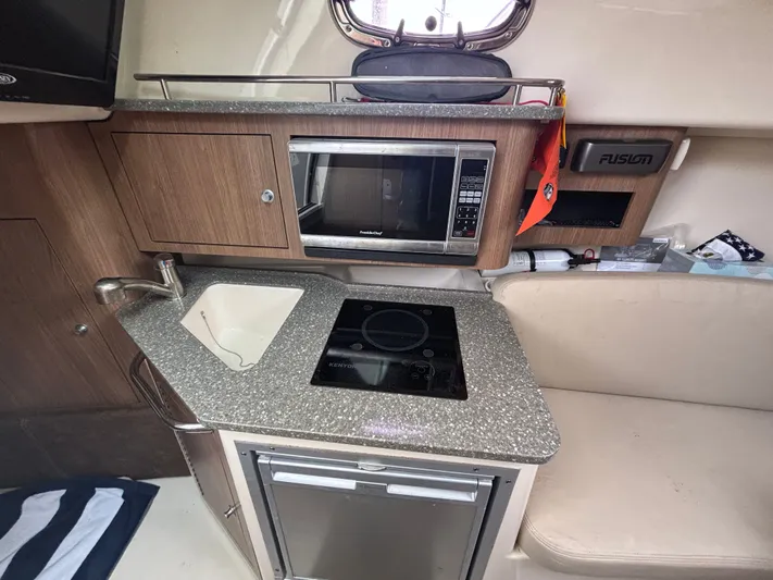  Yacht Photos Pics 2014 Boston Whaler 285 Conquest galley with sink, microwave, and cooktop.