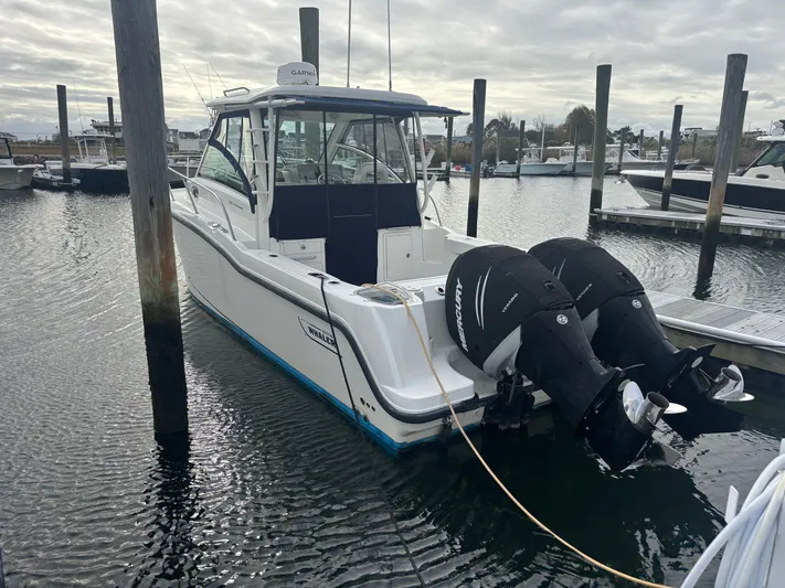  Yacht Photos Pics 2014 Boston Whaler 285 Conquest boat docked with twin Mercury engines.