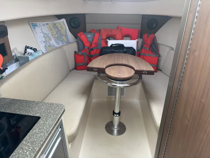  Yacht Photos Pics Interior of 2014 Boston Whaler 285 Conquest with seating, table, and life jackets.