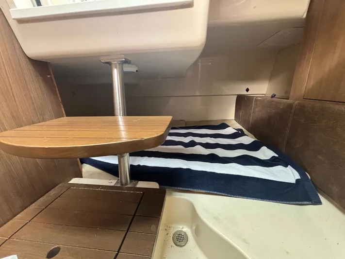  Yacht Photos Pics Interior cabin of 2014 Boston Whaler 285 Conquest with striped towel and wooden table.