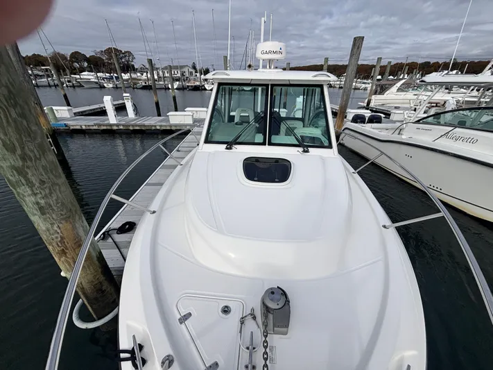  Yacht Photos Pics 2014 Boston Whaler 285 Conquest docked at marina, featuring Garmin equipment.