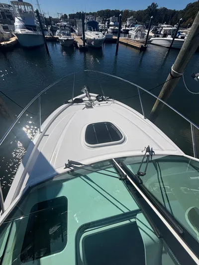  Yacht Photos Pics 2014 Boston Whaler 285 Conquest docked in a marina, viewed from the bow.
