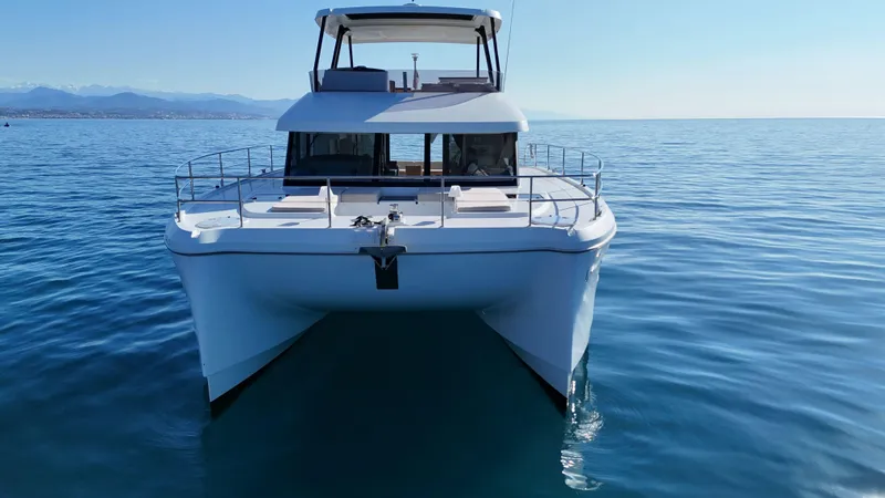 Barcajack Yacht Photos Pics 2022 Fountaine Pajot MY6 yacht on calm blue sea, front view.
