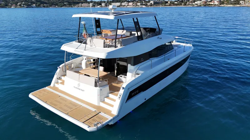 Barcajack Yacht Photos Pics 2022 Fountaine Pajot MY6 yacht on calm blue water, showcasing sleek design and spacious deck.
