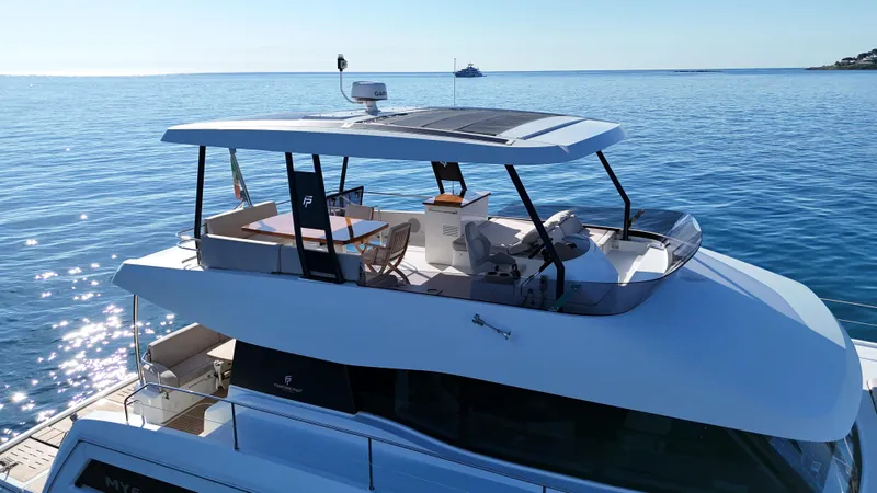 Barcajack Yacht Photos Pics 2022 Fountaine Pajot MY6 yacht on calm blue sea, featuring sleek design and spacious deck.