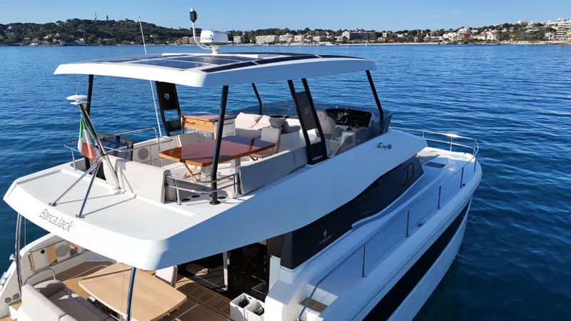 Barcajack Yacht Photos Pics 2022 Fountaine Pajot MY6 yacht on calm blue water, featuring spacious deck and modern design.