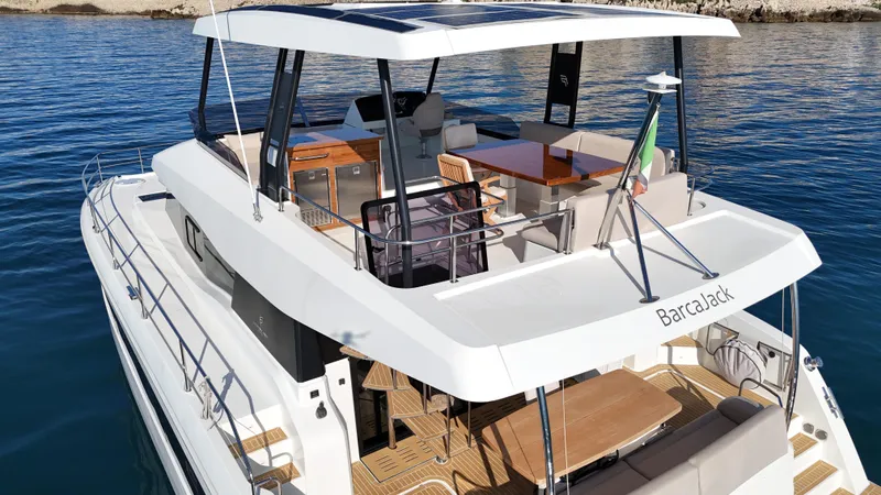 Barcajack Yacht Photos Pics 2022 Fountaine Pajot MY6 yacht with spacious deck and modern design on calm water.