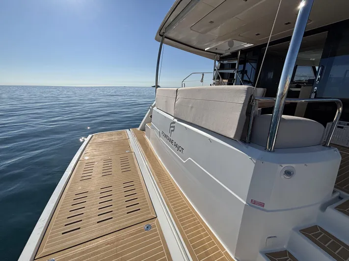 Barcajack Yacht Photos Pics 2022 Fountaine Pajot MY6 yacht with spacious deck, cruising on calm ocean waters.