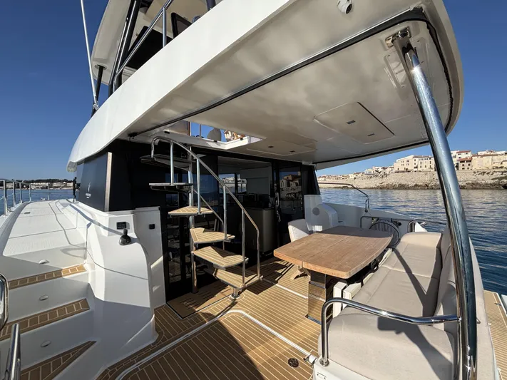 Barcajack Yacht Photos Pics 2022 Fountaine Pajot MY6 yacht deck with seating, table, and ocean view.