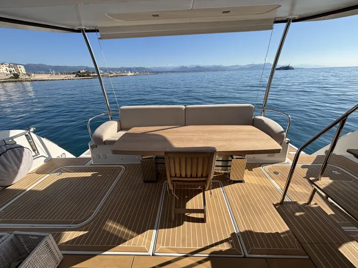 Barcajack Yacht Photos Pics Luxurious 2022 Fountaine Pajot MY6 yacht deck with seating, overlooking serene ocean view.