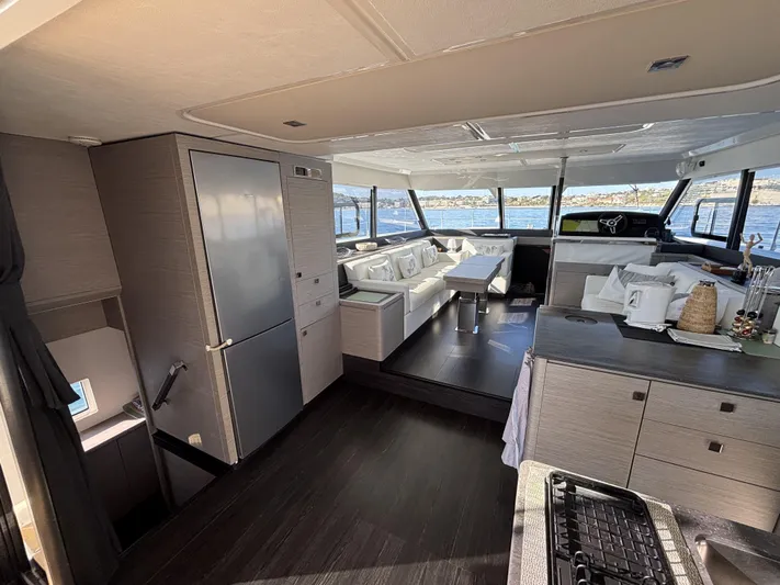 Barcajack Yacht Photos Pics Luxurious interior of 2022 Fountaine Pajot MY6 yacht with modern furnishings and panoramic windows.