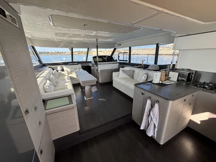 Barcajack Yacht Photos Pics Luxurious interior of 2022 Fountaine Pajot MY6 yacht with modern kitchen and seating area.