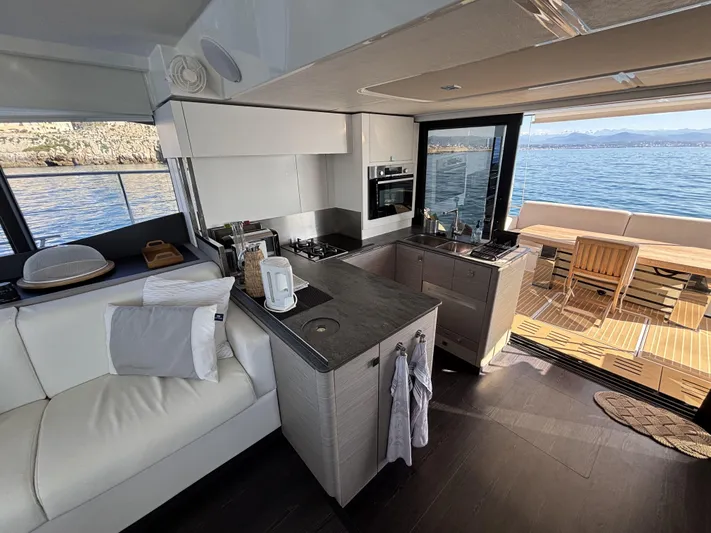 Barcajack Yacht Photos Pics Luxurious interior of 2022 Fountaine Pajot MY6 yacht with modern kitchen and ocean view.