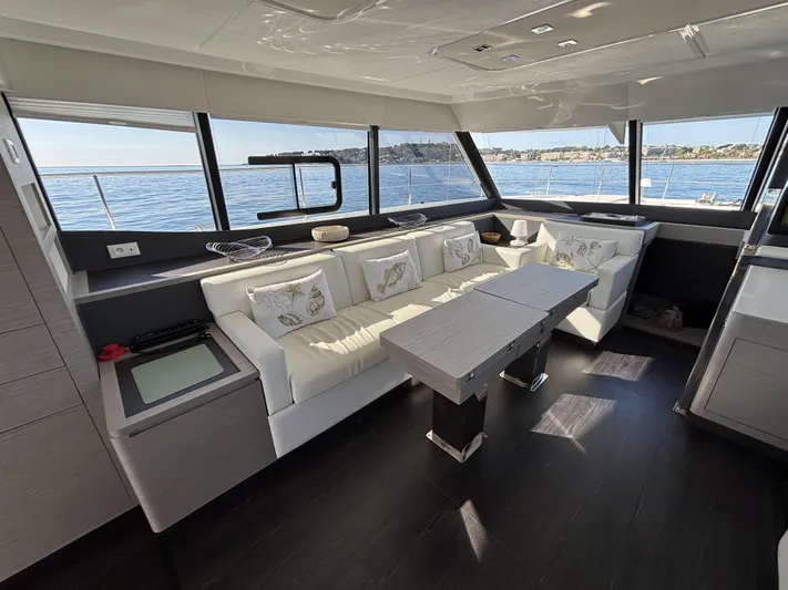 Barcajack Yacht Photos Pics Luxurious interior of 2022 Fountaine Pajot MY6 yacht with elegant seating and ocean view.